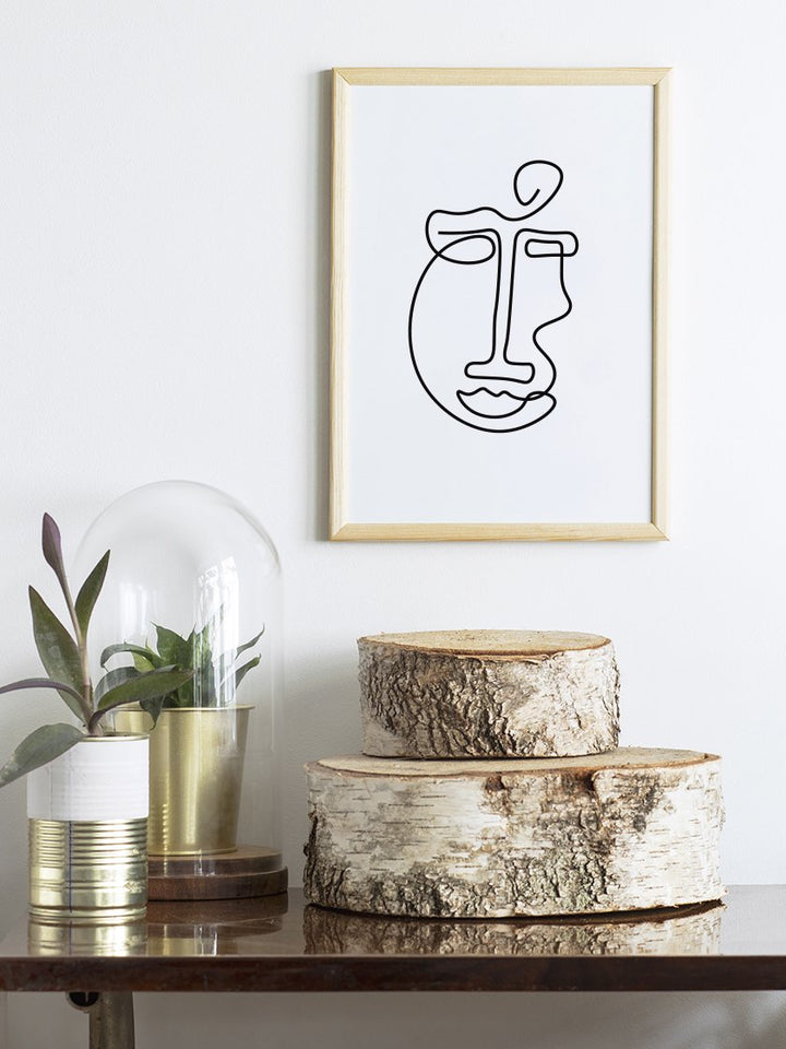 abstract-face-line-art-poster-on-a-table